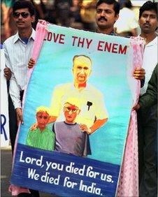 This November 23, 1999 file photo shows people carrying a portrait of Graham Staines, the Australian missionary who was murdered along with his two sons