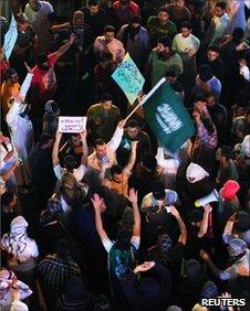 Protesters brandish placards in Qatif, 10 March 2011