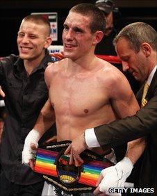 Liam Walsh receives his title as brother Michael watches