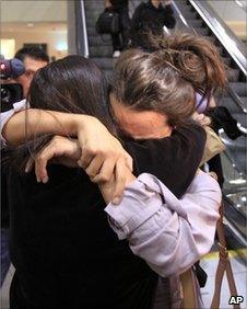 An unidentified Southwest Airlines flight 812 passenger, right, is hugged by a loved one after arriving at Sacramento International Airport Friday, April 1, 2011.