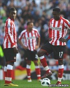 Asamoah Gyan and Danny Welbeck prepare for the restart