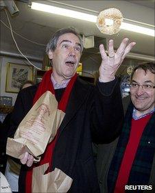 Michael Ignatieff throws a bagel in the air