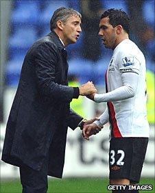 Roberto Mancini and Carlos Tevez