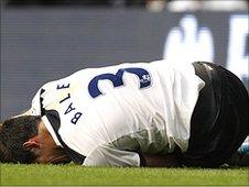 Gareth Bale holds his injured ankle