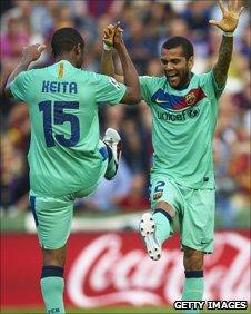 Seydou Keita and Dani Alves (right)