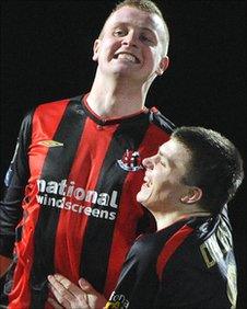 Jordan Owens celebrates a goal with Crusaders team-mate Stuart Dallas