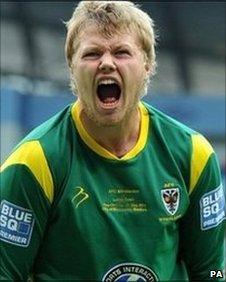 AFC Wimbledon keeper Seb Brown celebrates his side's victory and promotion