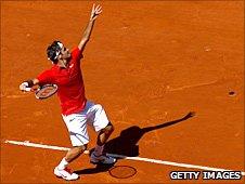 Roger Federer serves in Paris