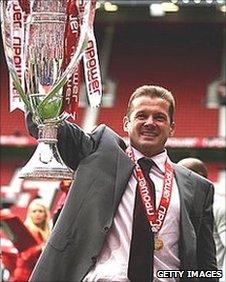 Stevenage manager Graham Westley celebrates with the trophy