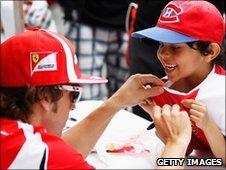 Ferrari driver Fernando Alonso and a fan in Canada