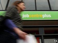 Woman walks past a job centre