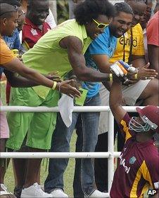 Chris Gayle shakes hands with Marlon Samuels