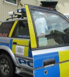 Policeman getting into a car