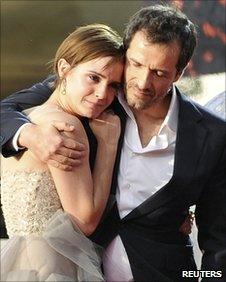 Producer David Heyman hugs actress Emma Watson