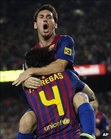 Messi celebrates scoring the winner with Fabregas