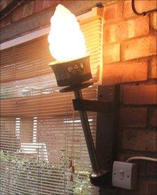 Olympic torch being used as a wall light