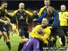 The East Fife players mob keeper Mark Ridgers