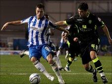Ashley Barnes of Brighton (L) evades Darren O'Dea of Leeds (R)