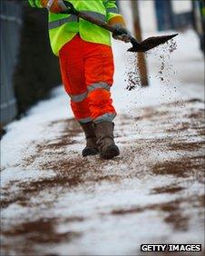 workman throwing grit