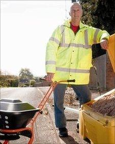 Dave Luckett, from Twyning Parish Council, standing with a hand spreader for salt