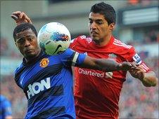 Liverpool striker Luis Suarez vies with Manchester United's Patrice Evra