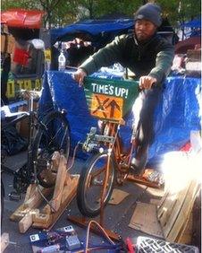 Occupy Wall Street protester Chris on a bike-operated generator