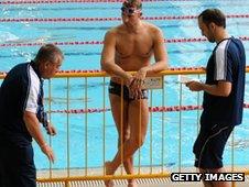 Ian Thorpe listens to Australian team officials during training ahead of the Singapore World Cup