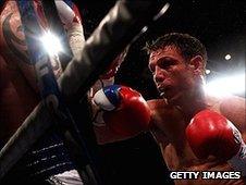 Michael Katsidis hammers into Ricky Burns on the ropes