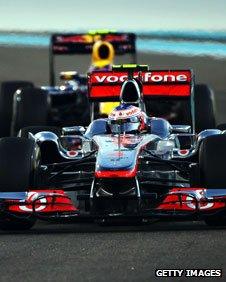 Jenson Button of Great Britain and McLaren leads from Mark Webber of Australia and Red Bull Racing during the Abu Dhabi Formula 1 Grand Prix