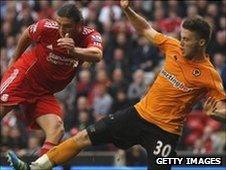 Matt Doherty slides in on Liverpool's Andy Carroll