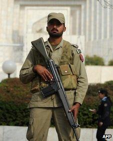 A Pakistani paramilitary soldier stands guard outside the supreme court building during the corruption case hearing in Islamabad on February 2, 2012.