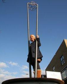 Liz Mannion underneath her sculpture.