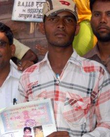 Child groom Rakesh holds the document that annuls his marriage to Laxmi