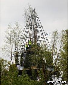 Workers prepare the pyramid design at Chelsea Flower Show