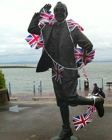 Statue of Eric Morecambe covered in Union Flag bunting