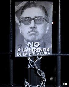 Poster of Pinochet on a barred door during protest