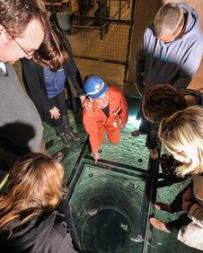 A guide and visitors at the top of the shaft