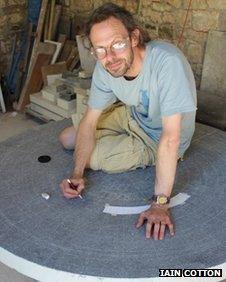 Artist Iain Cotton working on the Cotswold Way trail marker