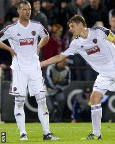 Hearts defender Andy Webster is given encouragement by captain Marius Zaliukas