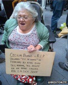 A protester in London was seen carrying a banner for Cecilia Burns at the protest outside Atos HQ