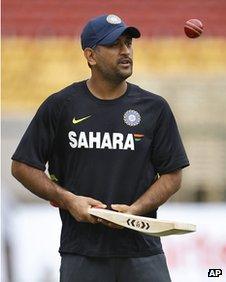 Indian cricket captain Mahendra Singh Dhoni tosses a ball during a training session in Bangalore, India, Wednesday, Aug. 29, 2012.