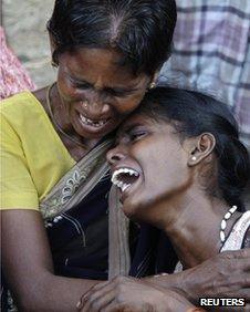 Family members mourn for their relatives, who died in the fireworks factory fire at Sivakasi town