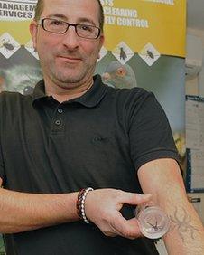 Ian Parkinson holding the Black Widow spider in a jar