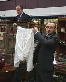 Porter holds up Queen Victoria's pants