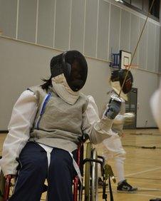 Karen Sutherland competes from her wheelchair against able-bodied fencers