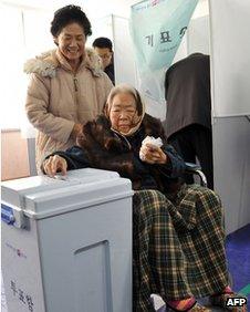 An elderly woman casts her ballot in Nonsan, South Korea, on 19 December 2012