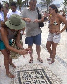 A woman uses a phone to scan a QR code