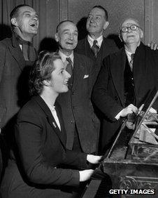 Margaret Thatcher in Dartford 1950 with four men watching her playing the piano