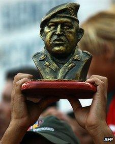 Chavez supporter holds the bust of "El Comandante"