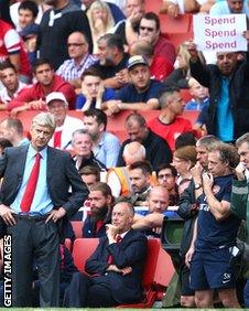 An Arsenal supporter tries to get his message across to Arsene Wenger